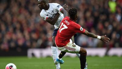 Liverpool's Senegalese striker Sadio Mane (L) vies with Manchester United's Brazilian midfielder Fred (R) during the English Premier League football match between Manchester United and Liverpool at Old Trafford in Manchester, north west England, on October 20, 2019. RESTRICTED TO EDITORIAL USE. No use with unauthorized audio, video, data, fixture lists, club/league logos or 'live' services. Online in-match use limited to 120 images. An additional 40 images may be used in extra time. No video emulation. Social media in-match use limited to 120 images. An additional 40 images may be used in extra time. No use in betting publications, games or single club/league/player publications. / AFP / Oli SCARFF / RESTRICTED TO EDITORIAL USE. No use with unauthorized audio, video, data, fixture lists, club/league logos or 'live' services. Online in-match use limited to 120 images. An additional 40 images may be used in extra time. No video emulation. Social media in-match use limited to 120 images. An additional 40 images may be used in extra time. No use in betting publications, games or single club/league/player publications.
