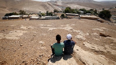 Palestinian boys sit in the Bedouin village of Khan Al Ahmar near Jericho in the occupied West Bank. Mohamad Torokman / Reuters