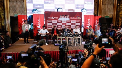 Mr Anwar, centre, insists his alliance won a simple majority. EPA