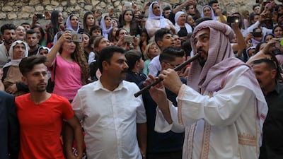 Iraqi Yazidis dance to traditional music at the Temple of Lalish, in a valley near the Kurdish city of Dohuk, in Iraq. AFP