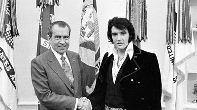 US President Richard Nixon, left, and rock 'n' roll musician Elvis Presley shake hands during a meeting at the White House on December 21, 1970. Getty Images