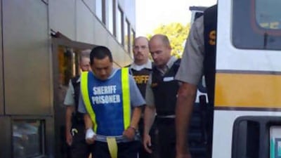 Vince Weiguang Li, 40, is led into the Manitoba Provincial Court in Portage La Prairie.