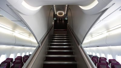 An access stairway leads to the first class cabins on the upper level of an Airbus A380 aircraft, operated by Qatar Airway. Jason Alden / Bloomberg