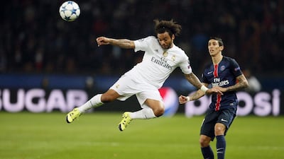 Real Madrid defender Marcelo lunges at the ball against PSG's Angel Di Maria on Wednesday night during their Champions League contest. Ian Langsdon / EPA / October 21, 2015