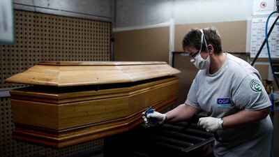 An employee works on a coffin at the manufacturing plant OGF in Jussey as the spread of the coronavirus disease continues in France. Reuters