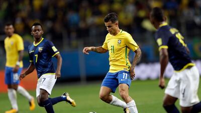 Philippe Coutinho, centre, is with Brazil and scored the second goal in a 2-0 win over Ecuador to ensure passage to the 2018 World Cup. Andre Penner / AP Photo