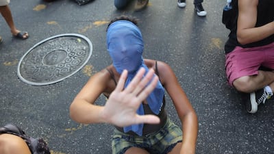 A girl shouts in protest on February 10, 2014, against a bus-fare increase in Rio de Janeiro, Brazil. Anti-government protests erupted across the country last June, hitting a peak as one million Brazilians took to streets on a single night, calling for better schools and health care, and questioning the billions spent to host this year’s World Cup and the 2016 Olympics. The protests have since diminished in size, but remain violent. Leo Correa / AP photo