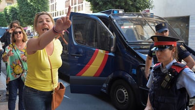 A woman reacts as National Police officers leave their hotel in Reus, south of Barcelona, Spain October 5, 2017.