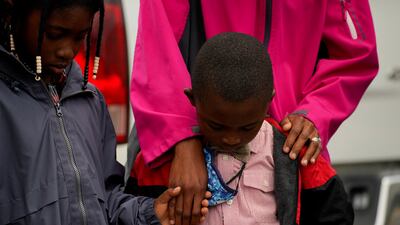 The Jacobs family prays during a vigil the day after the shooting. Reuters