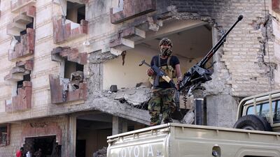 A police trooper mans a machine gun mounted on a patrol truck at the site of a car-bomb attack outside the finance ministry offices in the southern port city of Aden, Yemen on November 29, 2017. Fawaz Salman / Reuters