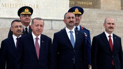 Turkish Justice Minister Abdulhamit Gul, second right, and Interior Minister Suleyman Soylu, right, stand with President Recep Tayyip Erdogan, second left, during a ceremony at the mausoleum of Mustafa Kemal Ataturk in Ankara on August 2, 2018. AP Photo