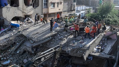 Rescue workers at a collapsed residential block in Karachi in 2020. Five people were killed when a three-storey building collapsed in the southern Pakistan city on Wednesday. AFP