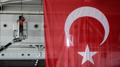 A worker cleans a wall at Ataturk airport in Istanbul after a triple suicide bombing attack killed 42 people. Omer Kuscu / AP Photo