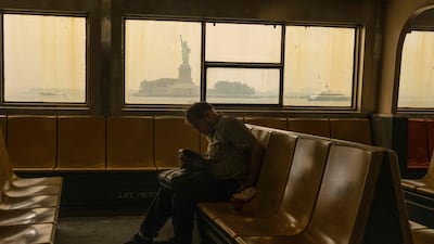 Haze from Canadian wildfires blankets the Statue of Liberty as seen from a Staten Island ferry. AFP
