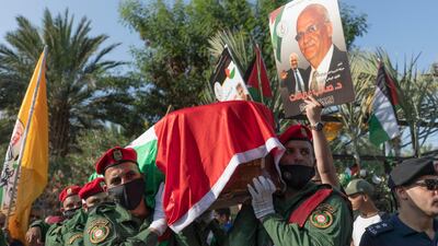A Palestinian honour guard carries the body of Saeb Erekat into the cemetery during his funeral in the West Bank town of Jericho, Wednesday, Novemver 11, 2020. AP
