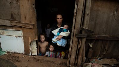 A family stands in their home in Brasilandia, one of Sao Paulo, Brazil’s poorest neighbourhoods. AP