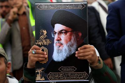 A Houthi supporter holds a portrait of Hezbollah leader Hassan Nasrallah, who was killed in 2024. EPA