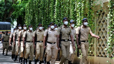 Members of police march as they arrive at the residence of Indian actor Dilip Kumar after he died in a hospital in Mumbai on July 7, 2021.