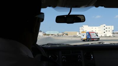 Farhan Husain, area manager of National Ambulance, follows the ambulance to the scene of an accident in Ajman. Pawan Singh / The National