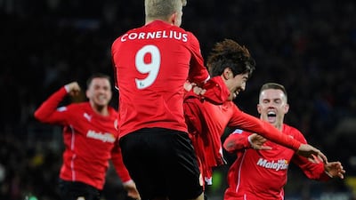 Kim Bo-Kyung, centre, of Cardiff City celebrates after heading in a goal in the 92nd minute against Manchester United on Sunday. Stu Forster / Getty Images