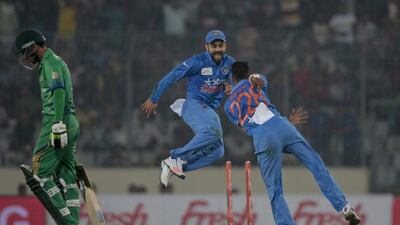 India’s Hardik Pandya, right, celebrates with his teammate Virat Kohli after the dismissal of Pakistan's Mohammed Amir, left, during their Asia Cup T20 match on Saturday night. AM Ahad / AP / February 27, 2016