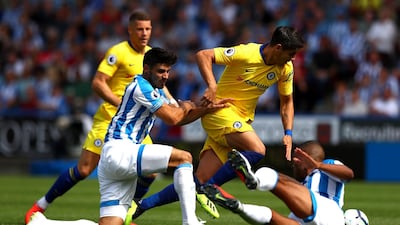 Alvaro Morata of Chelsea is challenged by Christopher Schindler and Mathias Zanka Jorgensen of Huddersfield Town. Getty Images