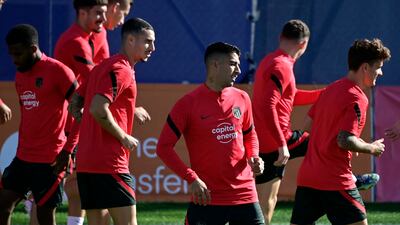 Atletico forward Luis Suarez, centre, training with teammates. AFP
