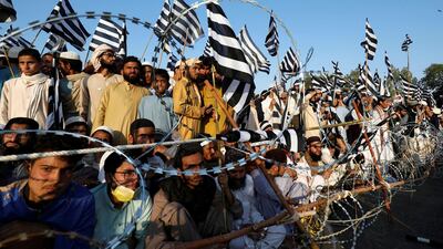 People wave flags as they listen to the speeches of leaders during an anti-Israel rally organized by the religious and political party Jamiat Ulema-e-Islam-Fazal as the outbreak of the coronavirus disease continues, in Karachi, Pakistan. Reuters