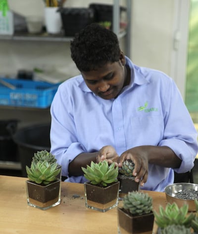 Abdulah Mubarak, an Enable students, creates an arrangement. Courtesy Desert Group