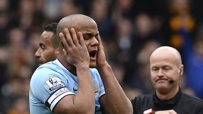 Manchester City's Vincent Kompany reacts after being sent off by referee Lee Mason during their English Premier League soccer match against Hull City at the KC stadium in Hull, northern England March 15, 2014. REUTERS/Nigel Roddis