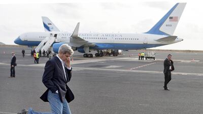 US Secretary of State John Kerry kicks a football around during an airplane refuelling stop on Sal Island in Cape Verde, enroute to Washington DC (REUTERS/Saul Loeb)