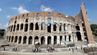 Tourists are seen visiting the ancient Colosseum, in Rome. Andrew Medichini / AP Photo