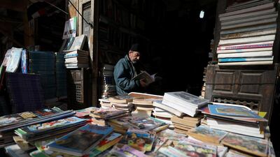A bookseller reads at Cairo's historic Al-Azbakeya market in Cairo, Egypt. Reuters