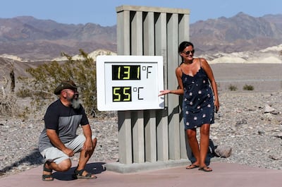Visitors in front of an unofficial thermometer at Furnace Creek Visitor Centre in Death Valley National Park, California. Getty Images