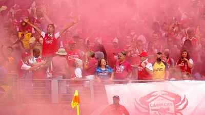 Arsenal fans celebrate a goal on Saturday. AP