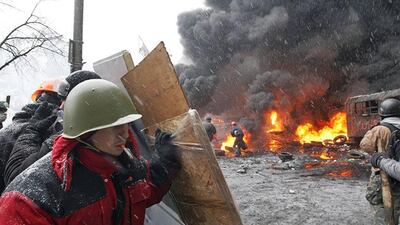 Protesters clash with riot police during an anti-government protest in downtown Kiev. Zurab Kurtsikidze / EPA