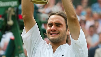 Roger Federer holds up the Wimbledon trophy after defeating Mark Philippoussis of Australia in 2003. AFP