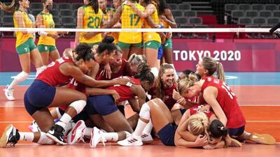 US players (celebrate after defeating Brazil in the women's volleyball gold medal match.