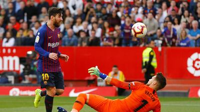 Messi flicks home his and Barcelona's third goal against Sevilla. Reuters