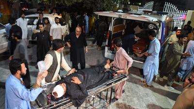 Medical personnel push a stretcher carrying a victim injured in the Quetta suicide bombing into an ambulance. AFP
