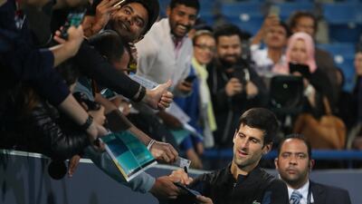 Novak Djokovic, an obvious crowd favourite here, signs autographs moments after winning the championship. Suhaib Salem / Reuters