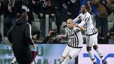 Juventus' Simone Zaza is celebrated by teammate Patrice Evra. REUTERS/Giorgio Perottino