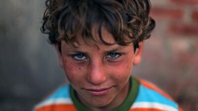 Palestinian refugee Ahmed Sameer, 10, poses for a photograph in Gezirat al-Fadel village, Sharqiya.
