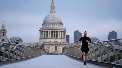 A jogger runs across the Millennium Bridge. AFP