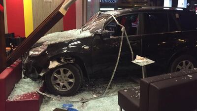 A family was injured when a car crashed into a fast food restaurant at a petrol station. Courtesy Ajman Police