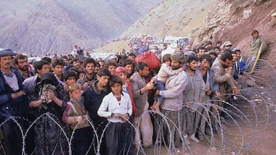 Thousands of Kurds in flight from Saddam Hussein's bloody suppression of the 1991 uprising in northern Iraq gather at a closed border in Doab, Iran, in search of sanctuary. Kaveh Kazemi / Getty Images.