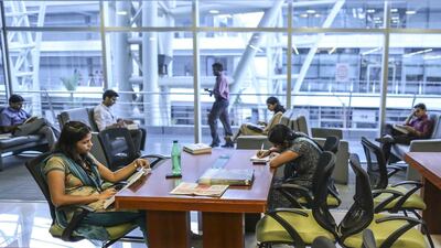 Employees sit working in the library of the Tata Consultancy Services campus in the State Industries Promotion Corporation of Tamil Nadu IT Park in the Siruseri area of Chennai, India. Dhiraj Singh / Bloomberg
