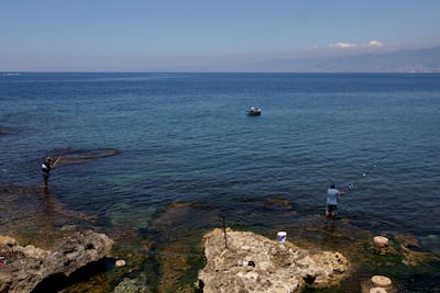 People fish off Beirut's Corniche. Reuters