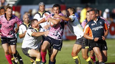 Xodus Steelers, in pink, were not to be stopped by J9 Legends on their way to the Action from the Dubai Rugby Sevens International Veterans title on Saturday at The Sevens, Dubai. Jake Badger for The National