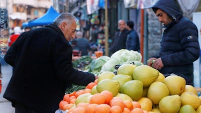 Khawla, Palestine: Khawla takes a well-timed photo of an old man shopping for groceries in the local vegetable market in Hebron, Palestine.
